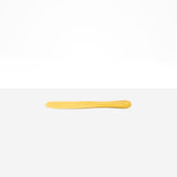 Dinosaur Designs Temple Cake Knife in Pollen — handcrafted marbled yellow and clear resin cake knife with smooth tapered blade and rounded handle.