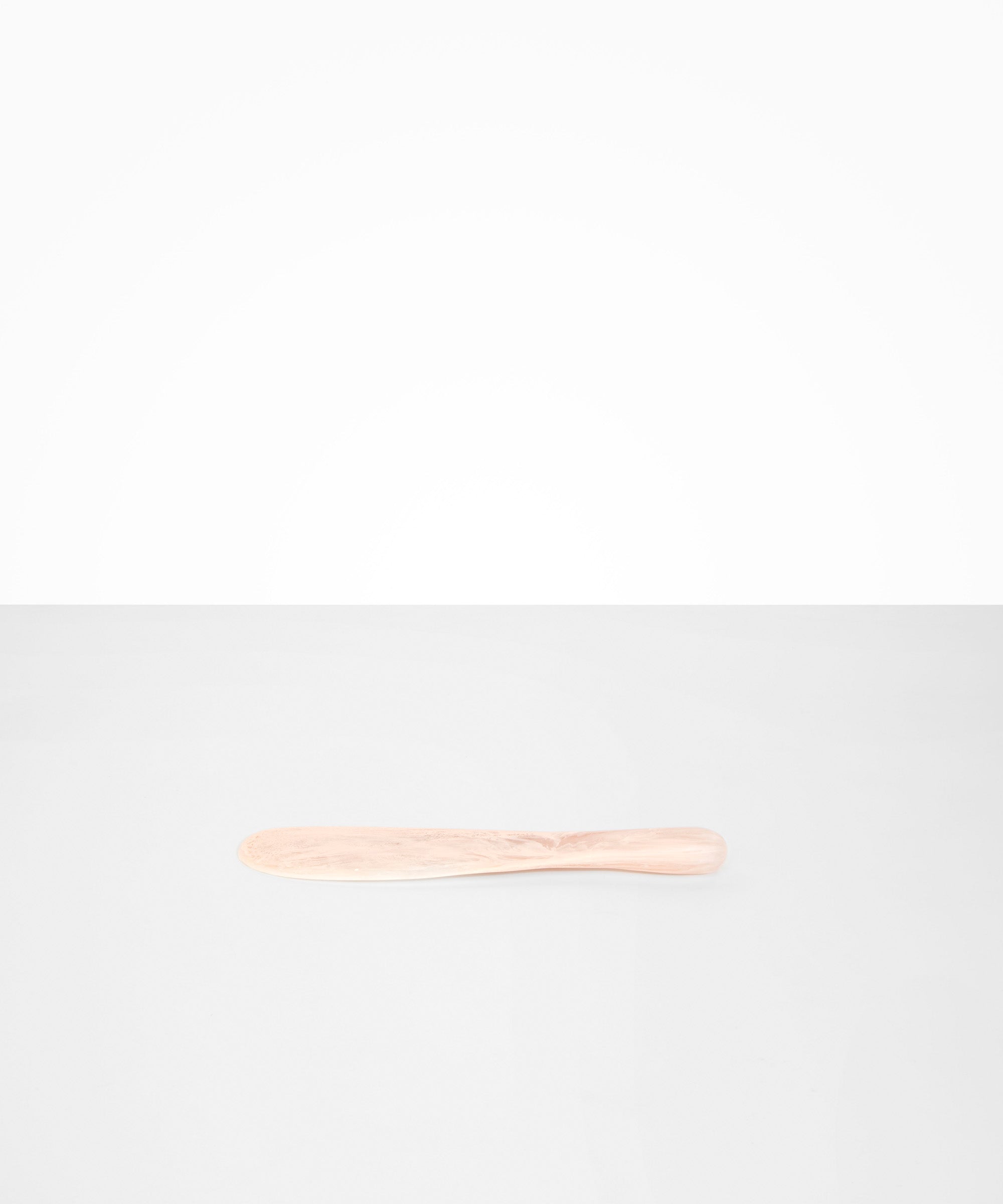 Dinosaur Designs Temple Cake Knife in Rose Swirl — handcrafted marbled dusty pink resin cake knife with smooth tapered blade and rounded handle.
