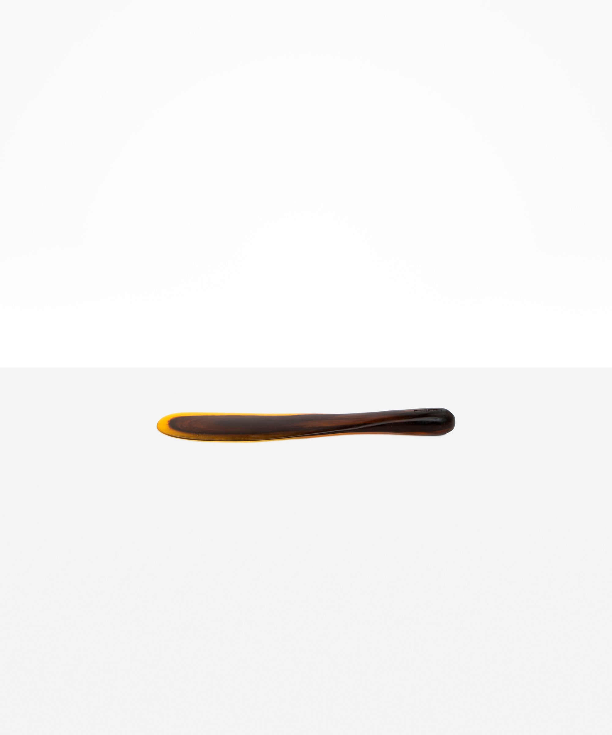 Dinosaur Designs Temple Cake Knife in Tortoise — handcrafted marbled amber and black resin cake knife with smooth tapered blade and rounded handle.