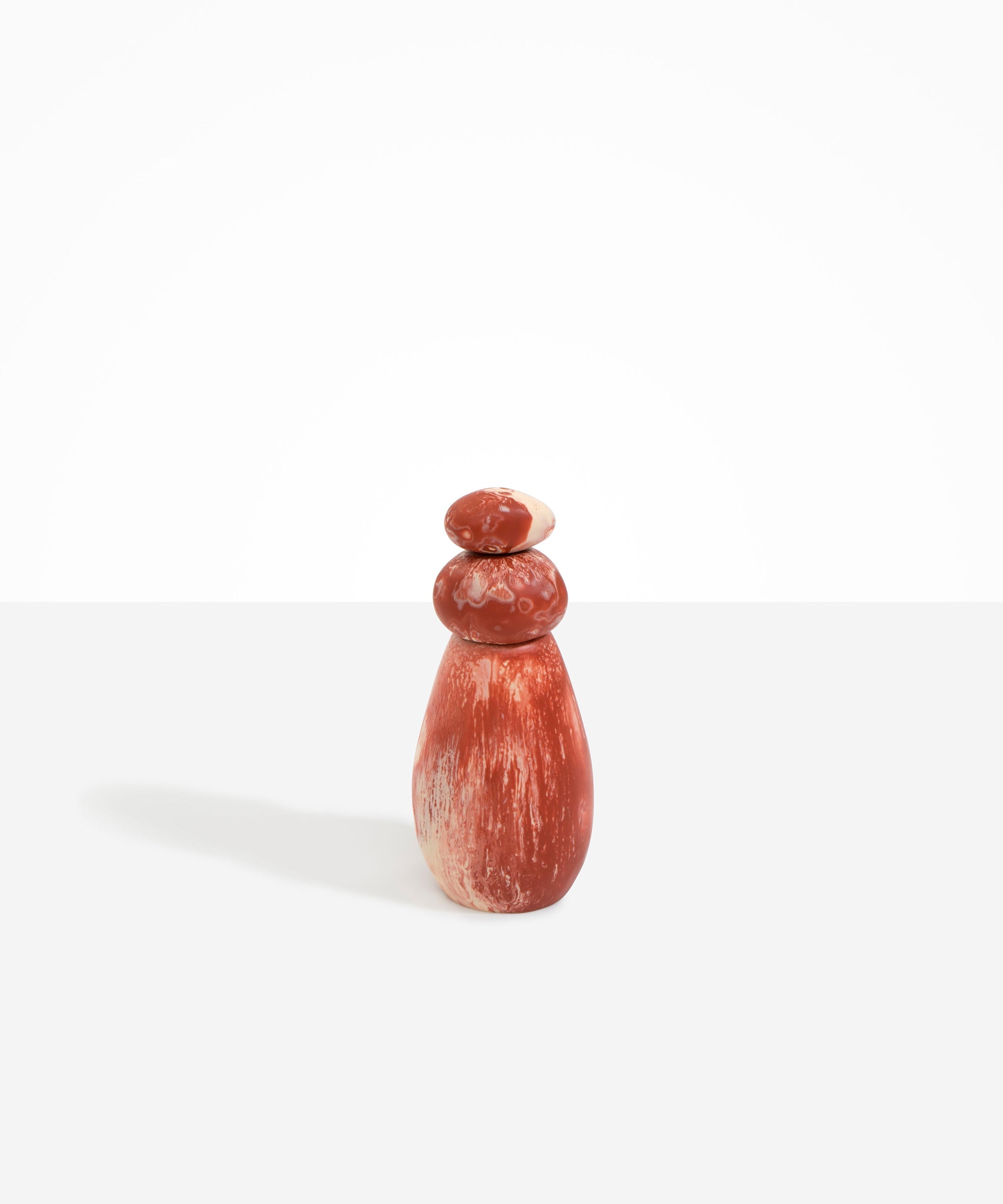 Dinosaur Designs Tall Pepper Boulder Grinder in Rust — handcrafted marbled terracotta red and cream resin pepper grinder with elongated teardrop body and stacked pebble lid