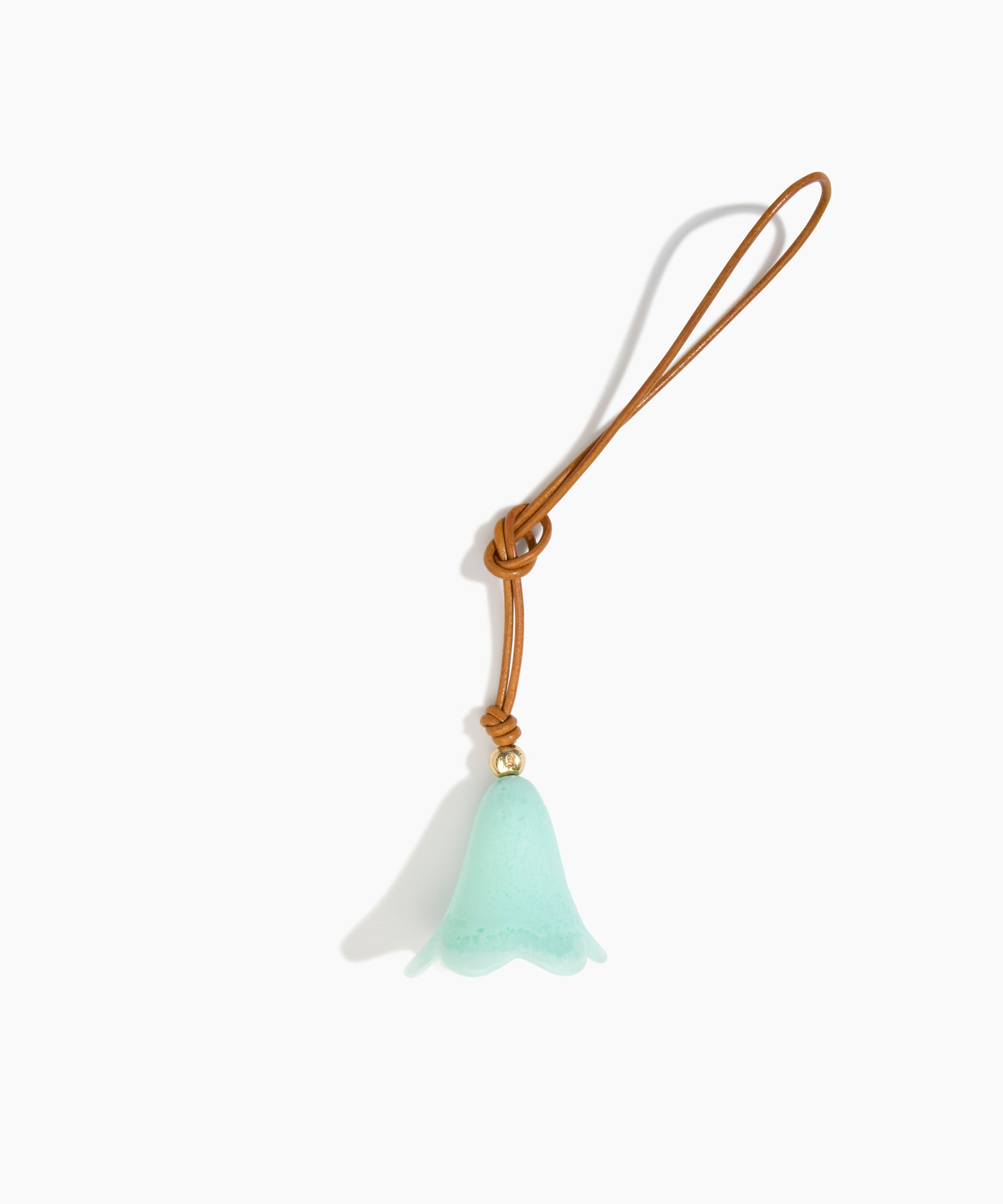 Dinosaur Designs Flower Bag Charm in Mint colour with Brass bead — handcrafted marbled mint blue resin bell-shaped flower bag charm with tan leather hanging loop and brass bead