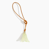 Dinosaur Designs Flower Bag Charm in Pistachio colour with Brass bead — handcrafted marbled pastel green resin bell-shaped flower bag charm with tan leather hanging loop and brass bead