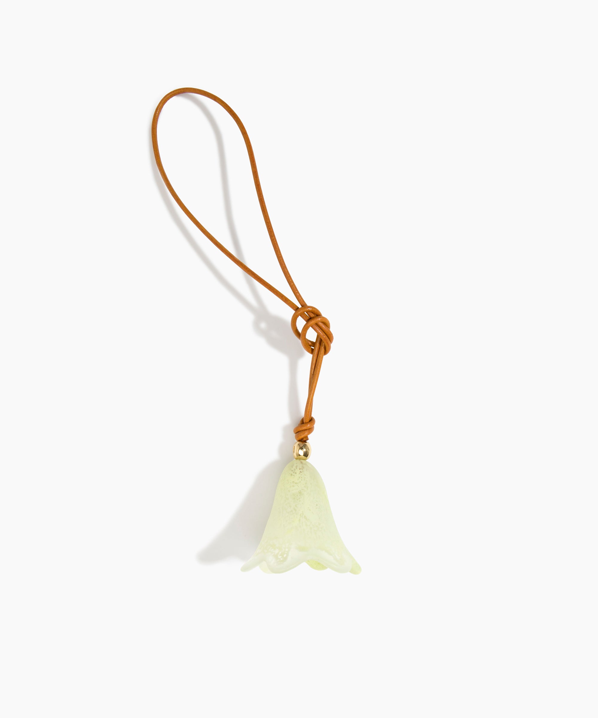 Dinosaur Designs Flower Bag Charm in Pistachio colour with Brass bead — handcrafted marbled pastel green resin bell-shaped flower bag charm with tan leather hanging loop and brass bead