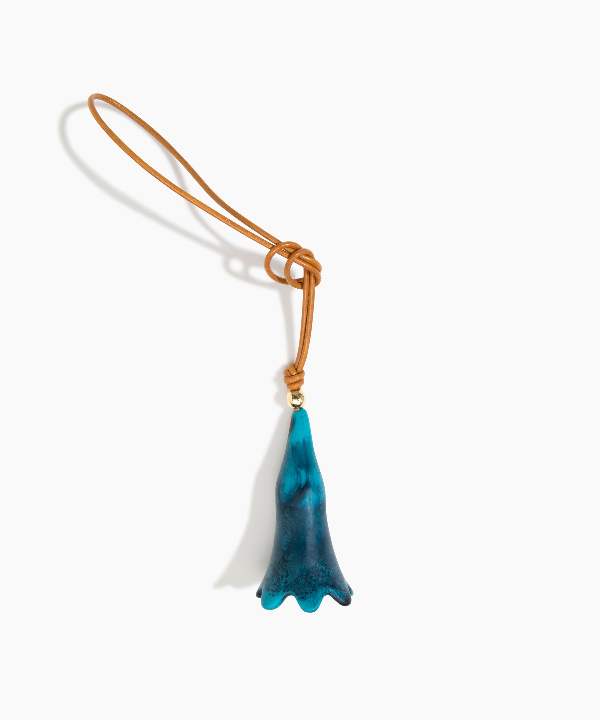 Dinosaur Designs Long Flower Bag Charm in Turquoise colour with Brass bead — handcrafted marbled teal blue resin bell-shaped flower bag charm with tan leather hanging loop and brass bead