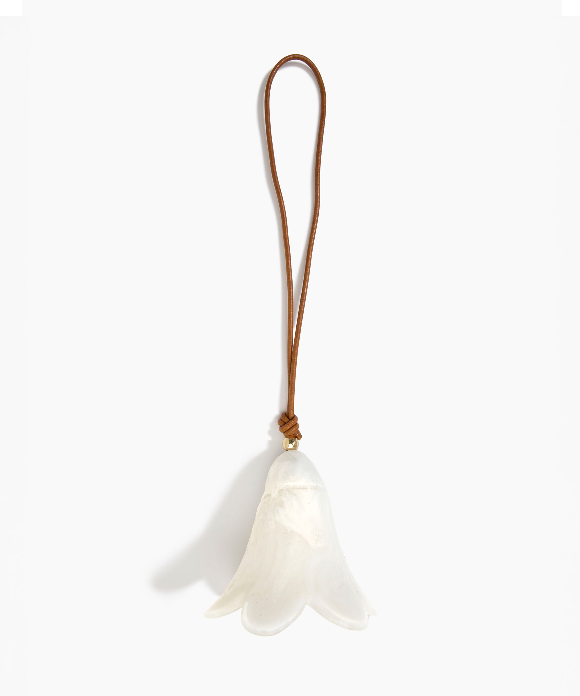 Dinosaur Designs Flower Decoration in Chalk Swirl colour with Brass bead — handcrafted marbled off-white resin bell-shaped flower ornament with tan leather hanging loop and brass bead