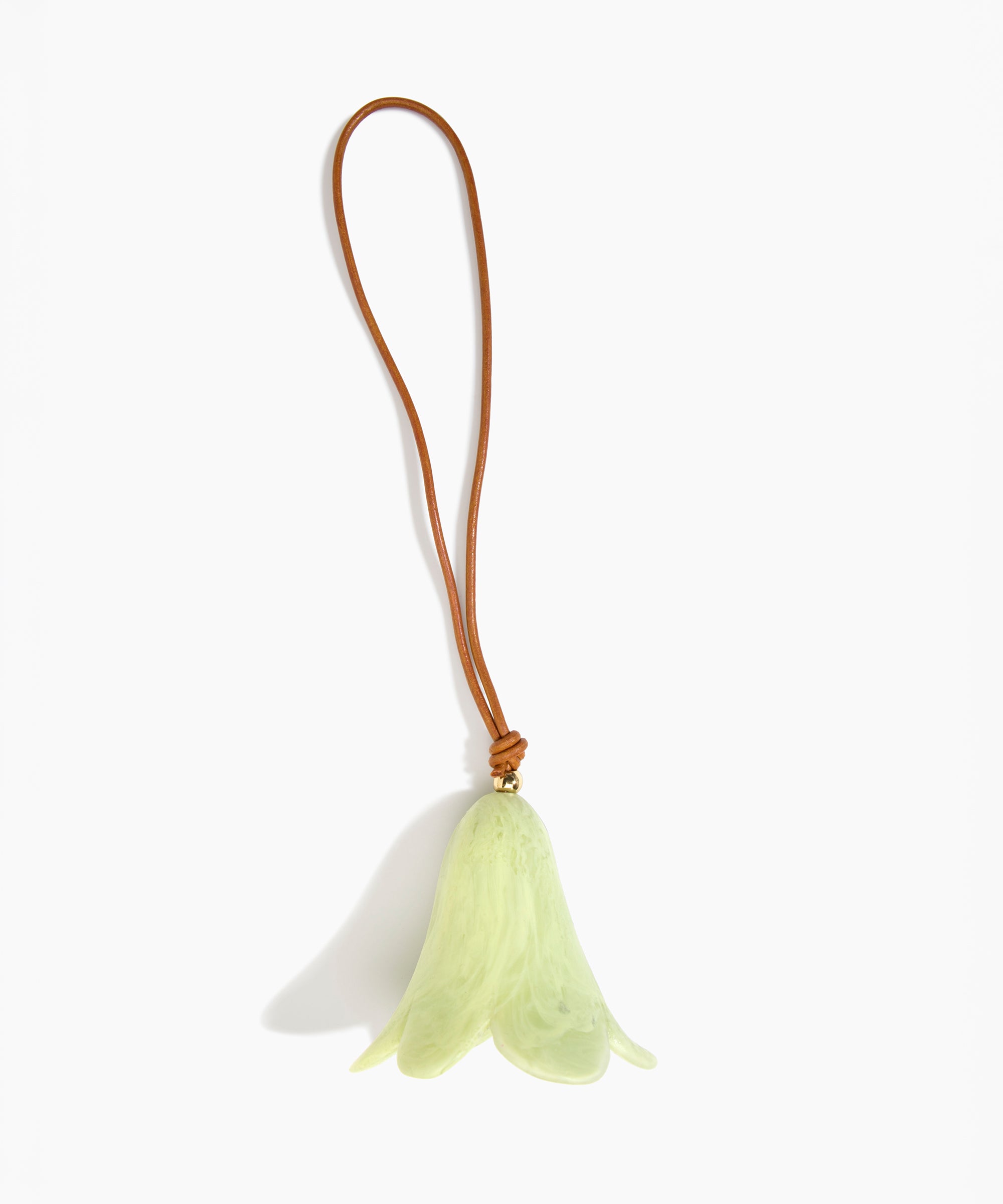 Dinosaur Designs Flower Decoration in Pistachio colour with Brass bead — handcrafted marbled pastel green resin bell-shaped flower ornament with tan leather hanging loop and brass bead