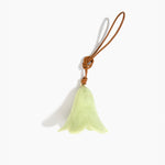 Dinosaur Designs Flower Decoration in Pistachio colour with Brass bead — handcrafted marbled pastel green resin bell-shaped flower ornament with tan leather hanging loop and brass bead