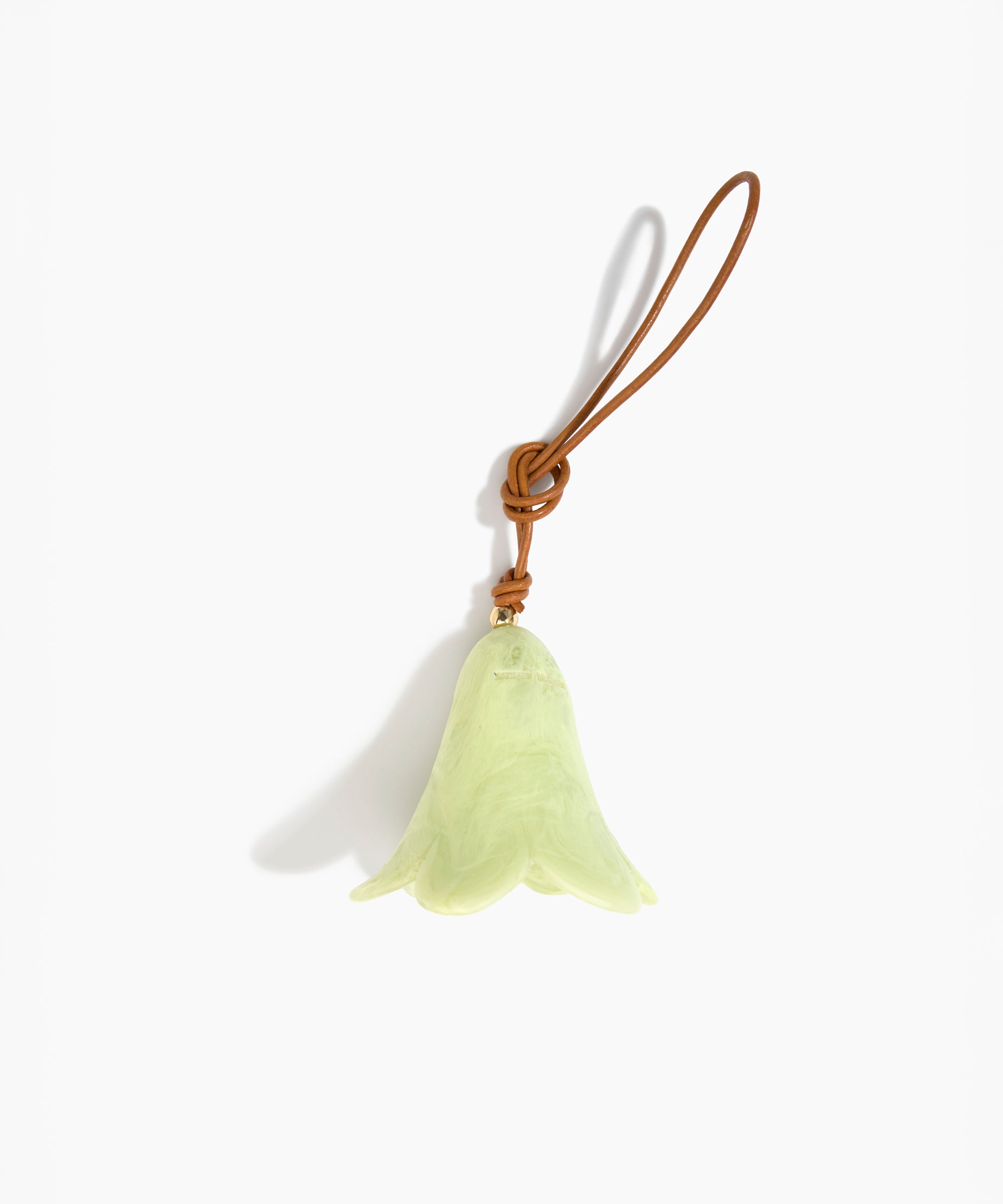 Dinosaur Designs Flower Decoration in Pistachio colour with Brass bead — handcrafted marbled pastel green resin bell-shaped flower ornament with tan leather hanging loop and brass bead