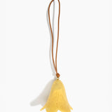 Dinosaur Designs Flower Decoration in Pollen colour with Brass bead — handcrafted marbled yellow resin bell-shaped flower ornament with tan leather hanging loop and brass bead