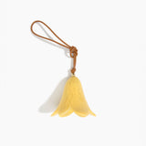 Dinosaur Designs Flower Decoration in Pollen colour with Brass bead — handcrafted marbled yellow resin bell-shaped flower ornament with tan leather hanging loop and brass bead