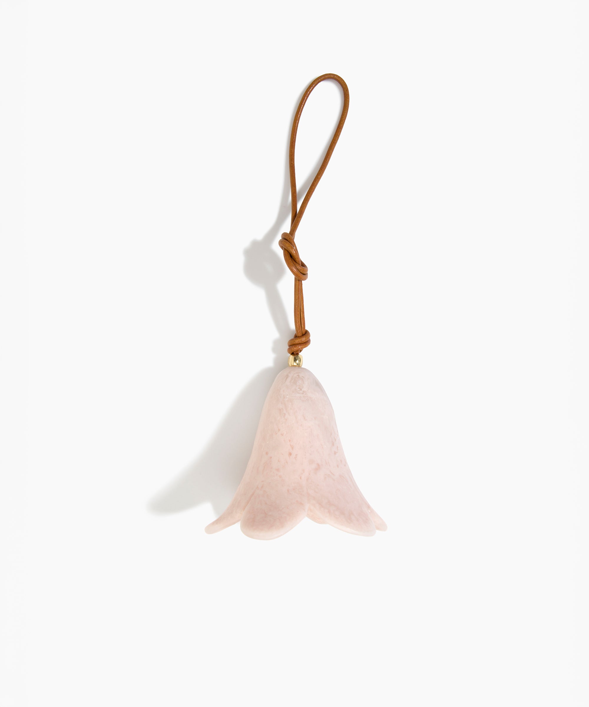 Dinosaur Designs Flower Decoration in Rose Swirl colour with Brass bead — handcrafted marbled dusty pink resin bell-shaped flower ornament with tan leather hanging loop and brass bead