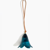 Dinosaur Designs Flower Decoration in Turquoise colour with Brass bead — handcrafted marbled teal blue resin bell-shaped flower ornament with tan leather hanging loop and brass bead