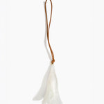 Dinosaur Designs Long Flower Decoration in Chalk Swirl colour with Brass bead — handcrafted marbled off-white resin bell-shaped flower ornament with tan leather hanging loop and brass bead