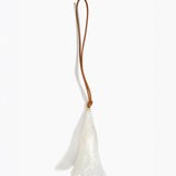 Dinosaur Designs Long Flower Decoration in Chalk Swirl colour with Brass bead — handcrafted marbled off-white resin bell-shaped flower ornament with tan leather hanging loop and brass bead