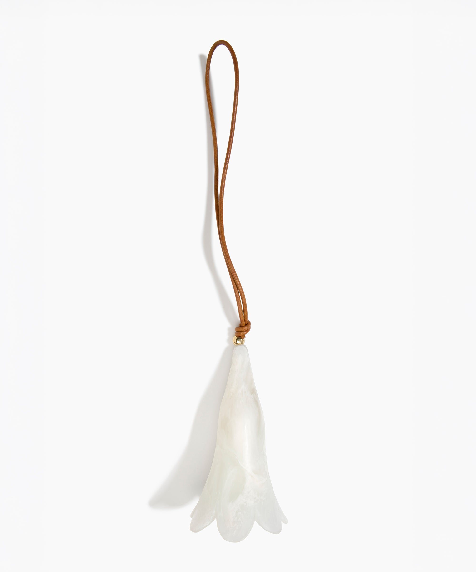 Dinosaur Designs Long Flower Decoration in Chalk Swirl colour with Brass bead — handcrafted marbled off-white resin bell-shaped flower ornament with tan leather hanging loop and brass bead