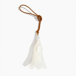 Dinosaur Designs Long Flower Decoration in Chalk Swirl colour with Brass bead — handcrafted marbled off-white resin bell-shaped flower ornament with tan leather hanging loop and brass bead