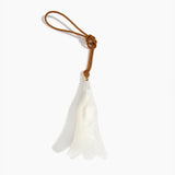 Dinosaur Designs Long Flower Decoration in Chalk Swirl colour with Brass bead — handcrafted marbled off-white resin bell-shaped flower ornament with tan leather hanging loop and brass bead