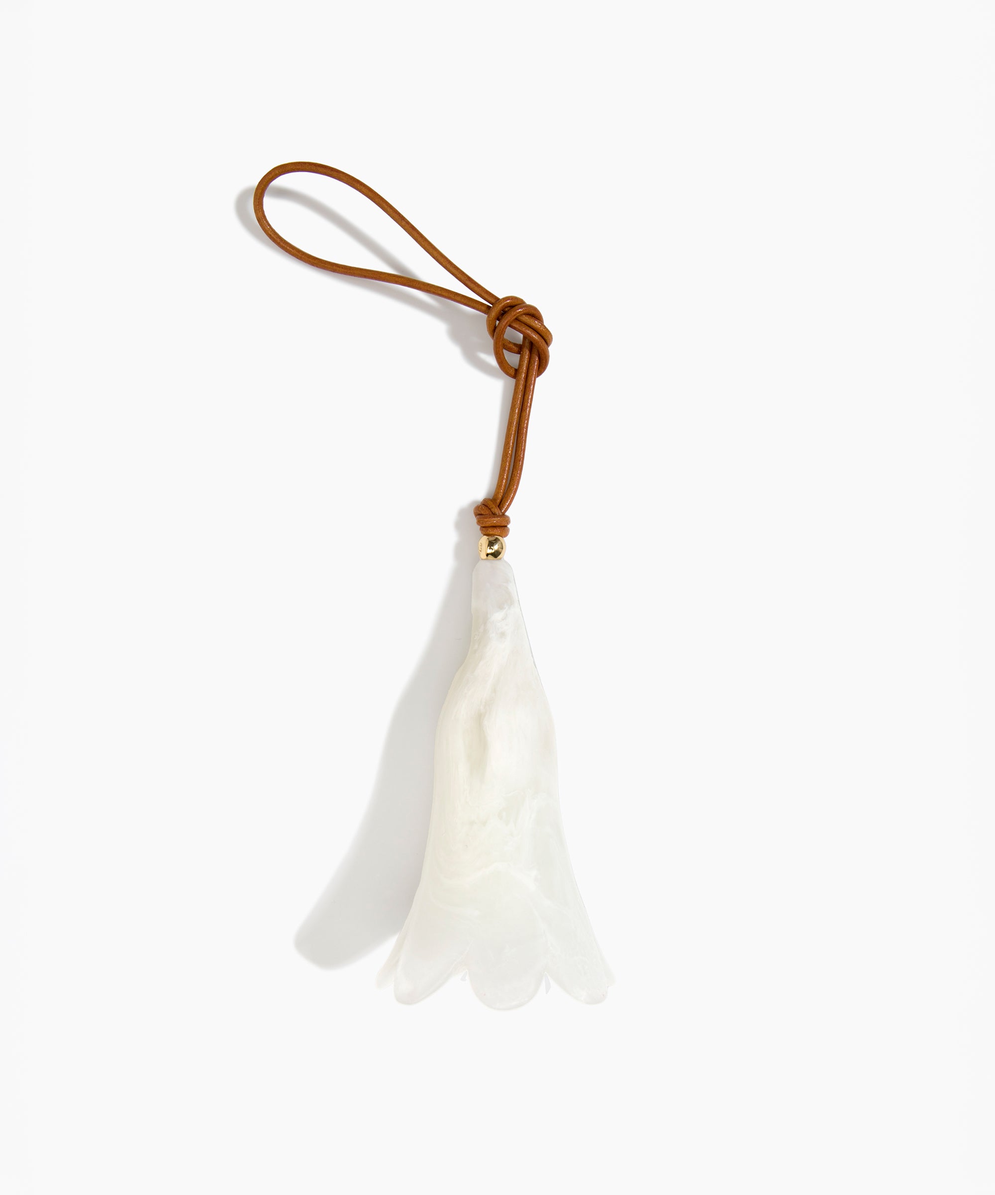 Dinosaur Designs Long Flower Decoration in Chalk Swirl colour with Brass bead — handcrafted marbled off-white resin bell-shaped flower ornament with tan leather hanging loop and brass bead