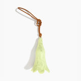 Dinosaur Designs Long Flower Decoration in Pistachio colour with Brass bead — handcrafted marbled pastel green resin bell-shaped flower ornament with tan leather hanging loop and brass bead