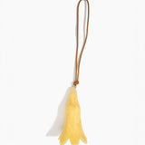 Dinosaur Designs Long Flower Decoration in Pollen colour with Brass bead — handcrafted marbled yellow resin bell-shaped flower ornament with tan leather hanging loop and brass bead