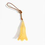 Dinosaur Designs Long Flower Decoration in Pollen colour with Brass bead — handcrafted marbled yellow resin bell-shaped flower ornament with tan leather hanging loop and brass bead