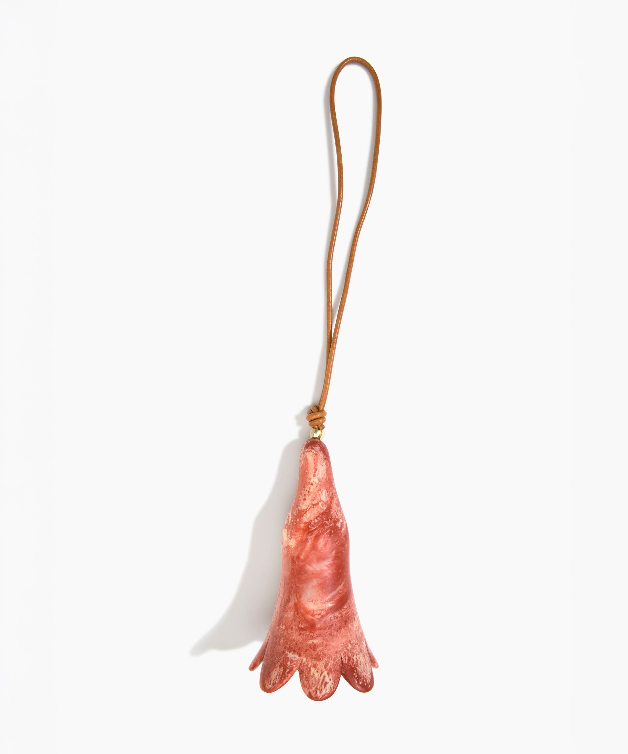 Dinosaur Designs Long Flower Decoration in Rust colour with Brass bead — handcrafted marbled terracotta red and cream resin bell-shaped flower ornament with tan leather hanging loop and brass bead