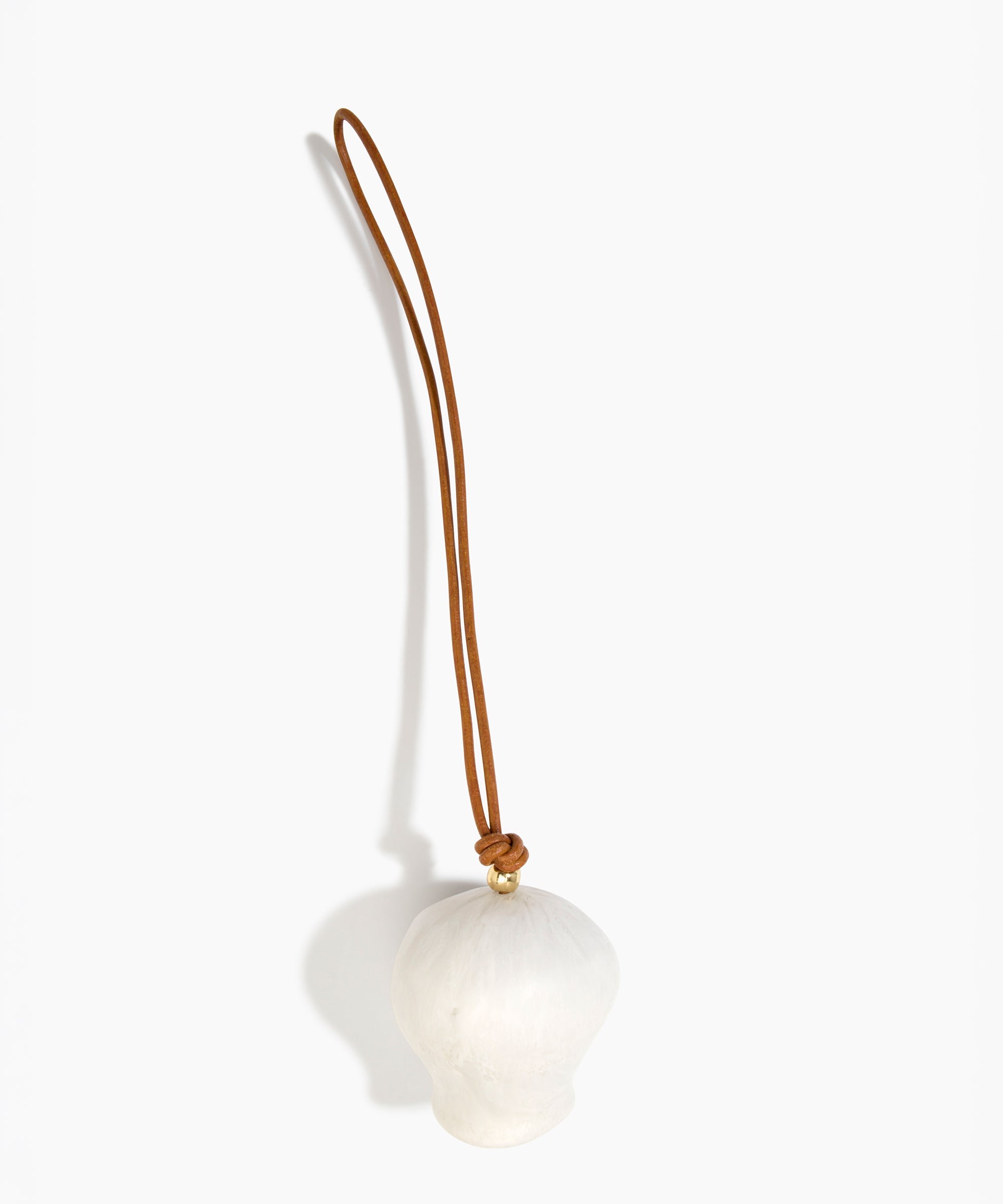 Dinosaur Designs Gumnut Decoration in Chalk Swirl colour with Brass hardware — handcrafted marbled off-white resin gumnut-shaped ornament with tan leather hanging loop and brass bead