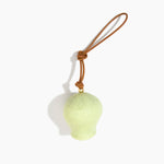 Dinosaur Designs Gumnut Decoration in Pistachio colour with Brass hardware — handcrafted marbled pastel green resin gumnut-shaped ornament with tan leather hanging loop and brass bead
