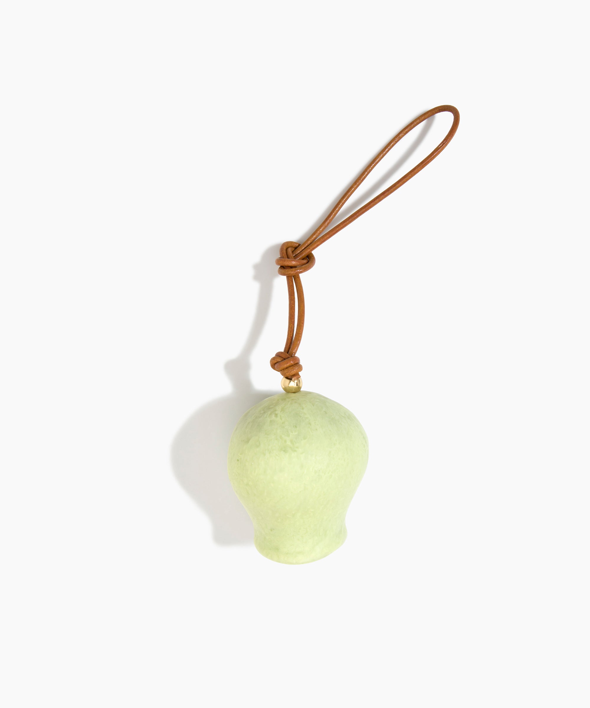 Dinosaur Designs Gumnut Decoration in Pistachio colour with Brass hardware — handcrafted marbled pastel green resin gumnut-shaped ornament with tan leather hanging loop and brass bead