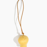 Dinosaur Designs Gumnut Decoration in Pollen colour with Brass hardware — handcrafted marbled yellow resin gumnut-shaped ornament with tan leather hanging loop and brass bead