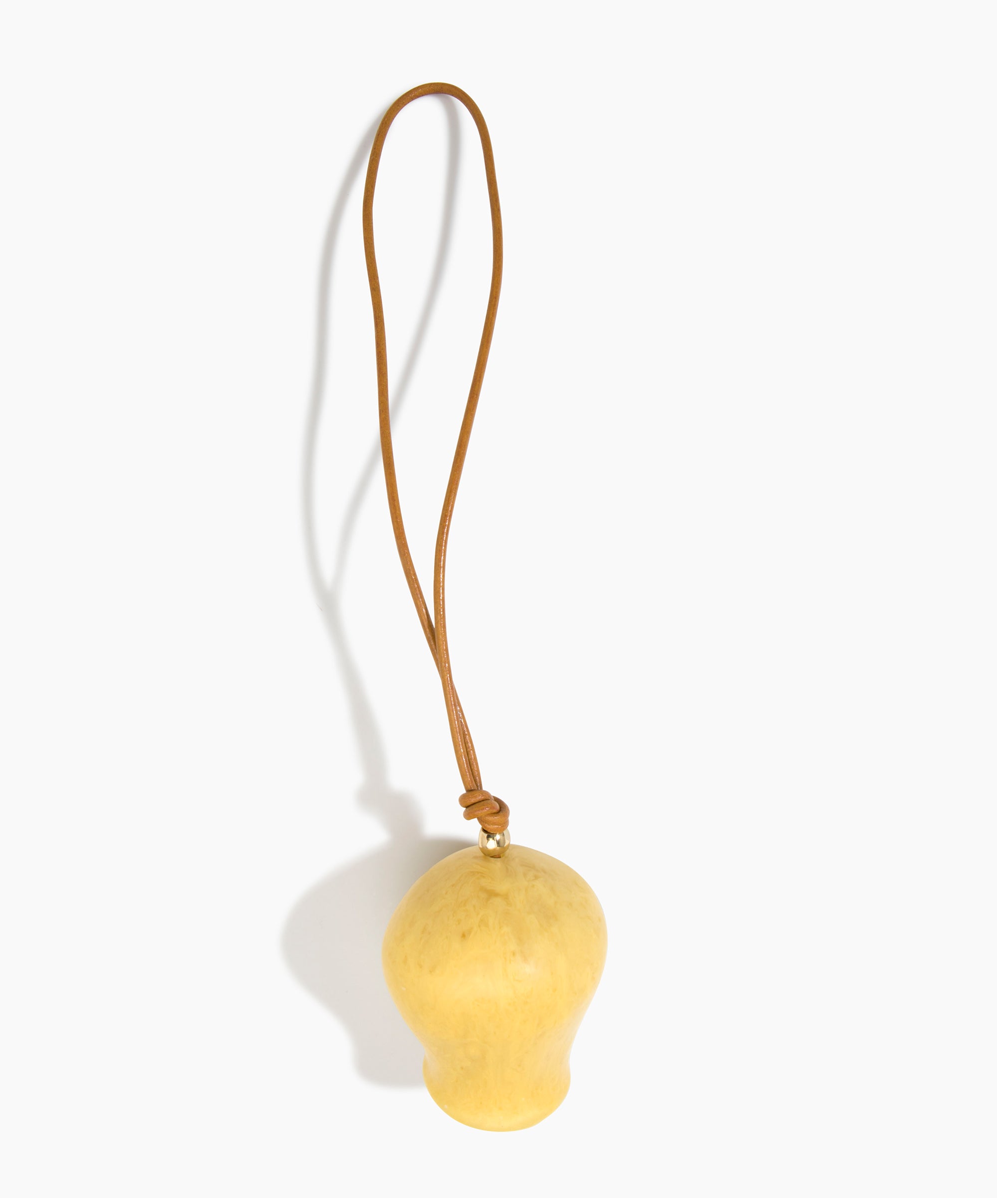 Dinosaur Designs Gumnut Decoration in Pollen colour with Brass hardware — handcrafted marbled yellow resin gumnut-shaped ornament with tan leather hanging loop and brass bead
