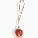 Dinosaur Designs Gumnut Decoration in Rust colour with Brass hardware — handcrafted marbled terracotta red and cream resin gumnut-shaped ornament with tan leather hanging loop and brass bead