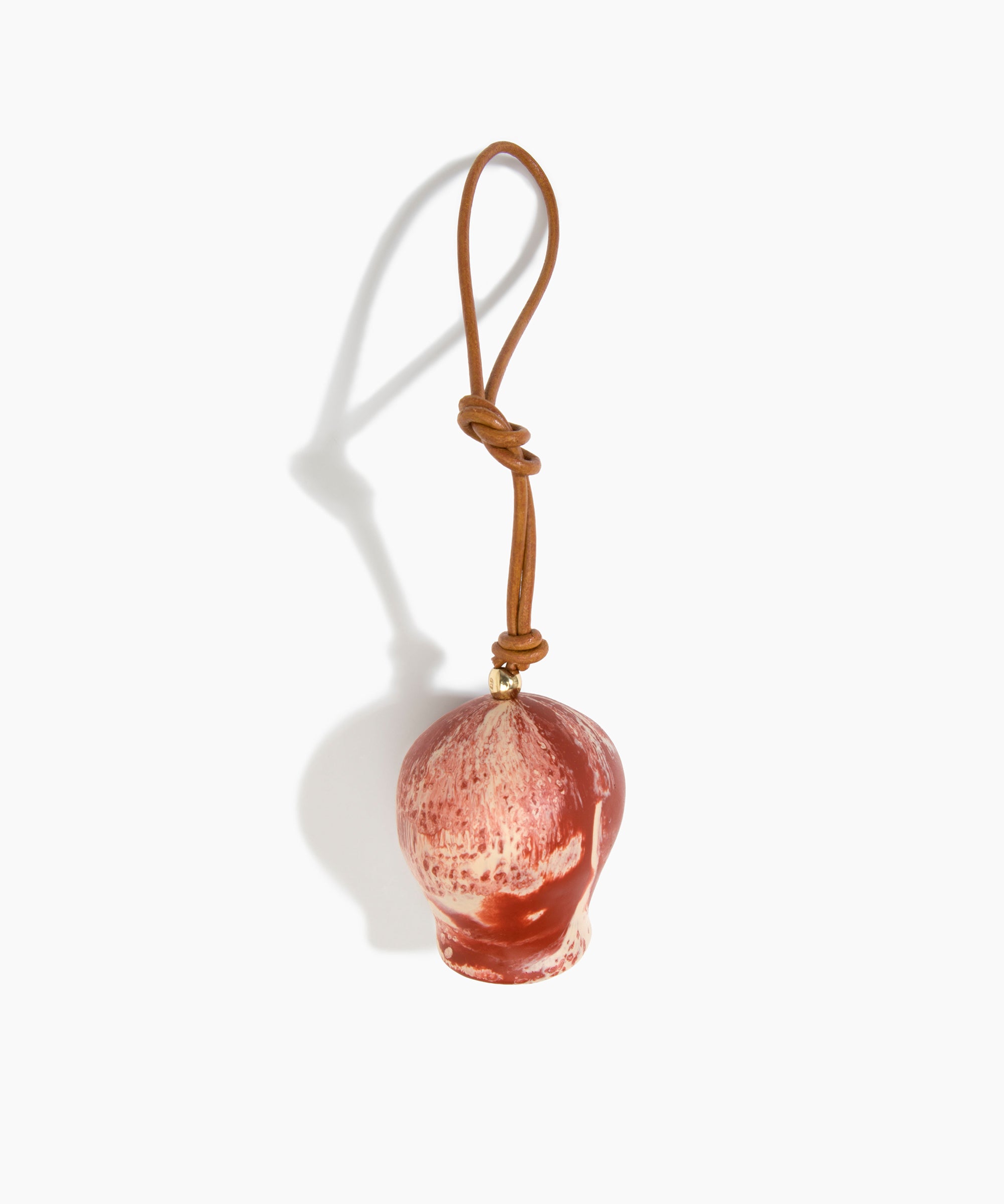 Dinosaur Designs Gumnut Decoration in Rust colour with Brass hardware — handcrafted marbled terracotta red and cream resin gumnut-shaped ornament with tan leather hanging loop and brass bead