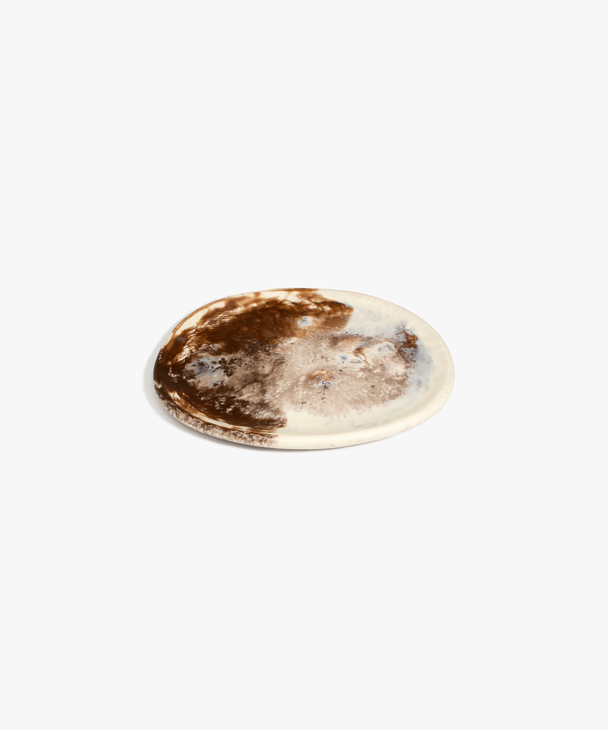 Dinosaur Designs Rock Plate in Cappuccino — handcrafted marbled brown and cream resin oval flat serving plate with rounded organic edge..