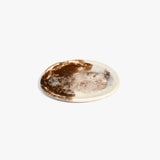 Dinosaur Designs Rock Plate in Cappuccino — handcrafted marbled brown and cream resin oval flat serving plate with rounded organic edge..
