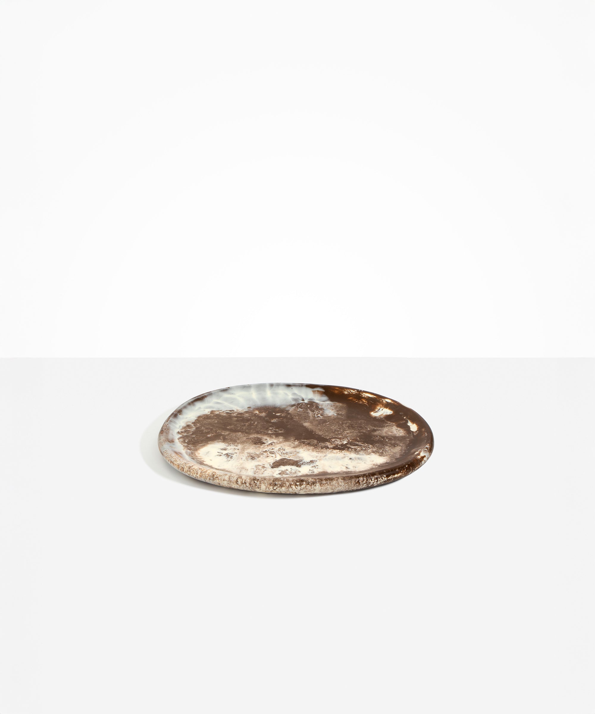 Dinosaur Designs Rock Plate in Cappuccino — handcrafted marbled brown and cream resin oval flat serving plate with rounded organic edge..