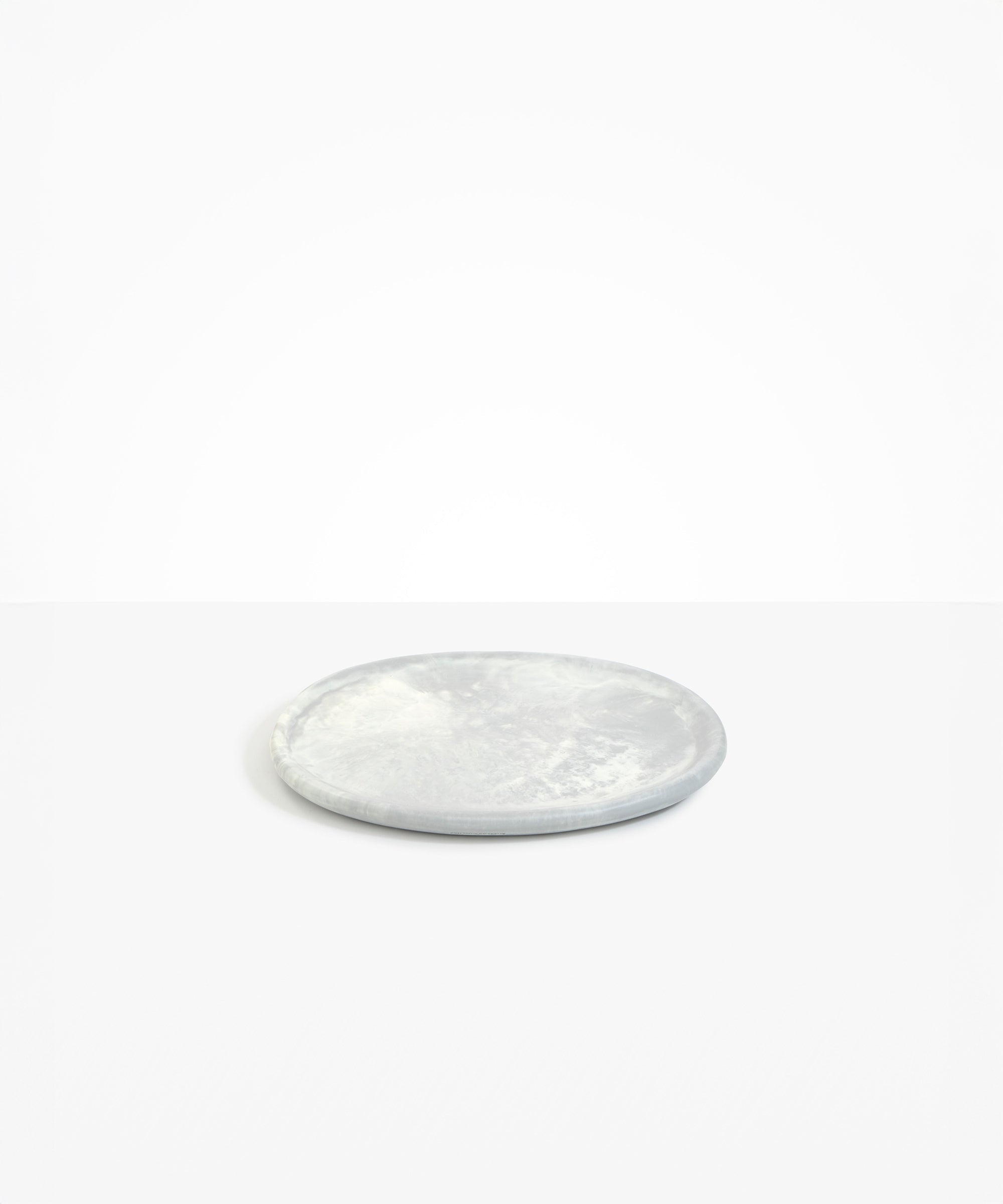 Dinosaur Designs Rock Plate in Cloud — handcrafted marbled grey and cream resin oval flat serving plate with rounded organic edge...