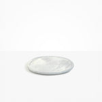 Dinosaur Designs Rock Plate in Cloud — handcrafted marbled grey and cream resin oval flat serving plate with rounded organic edge..