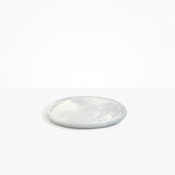Dinosaur Designs Rock Plate in Cloud — handcrafted marbled grey and cream resin oval flat serving plate with rounded organic edge..