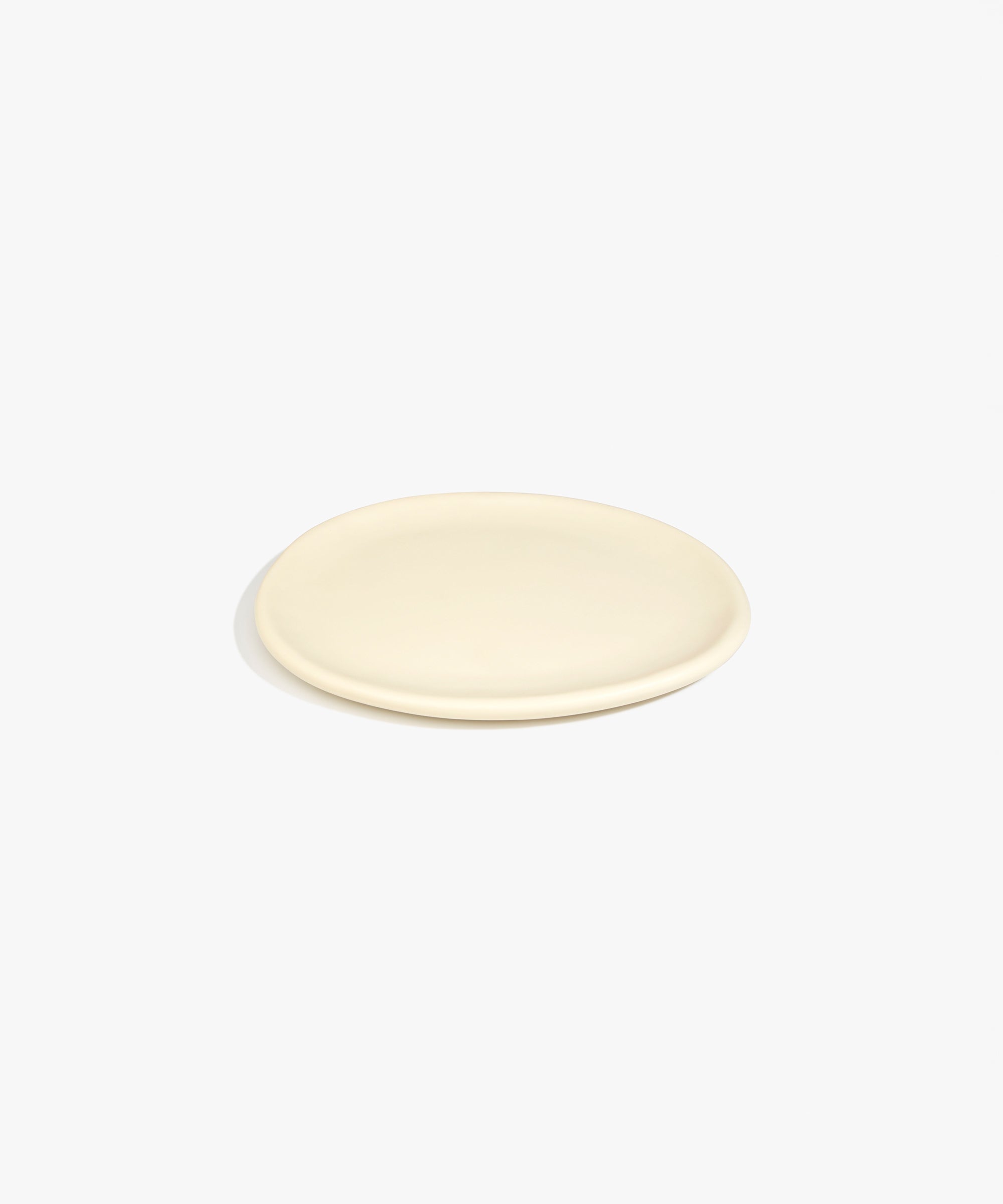 Dinosaur Designs Rock Plate in Cream — handcrafted cream resin oval flat serving plate with rounded organic edge