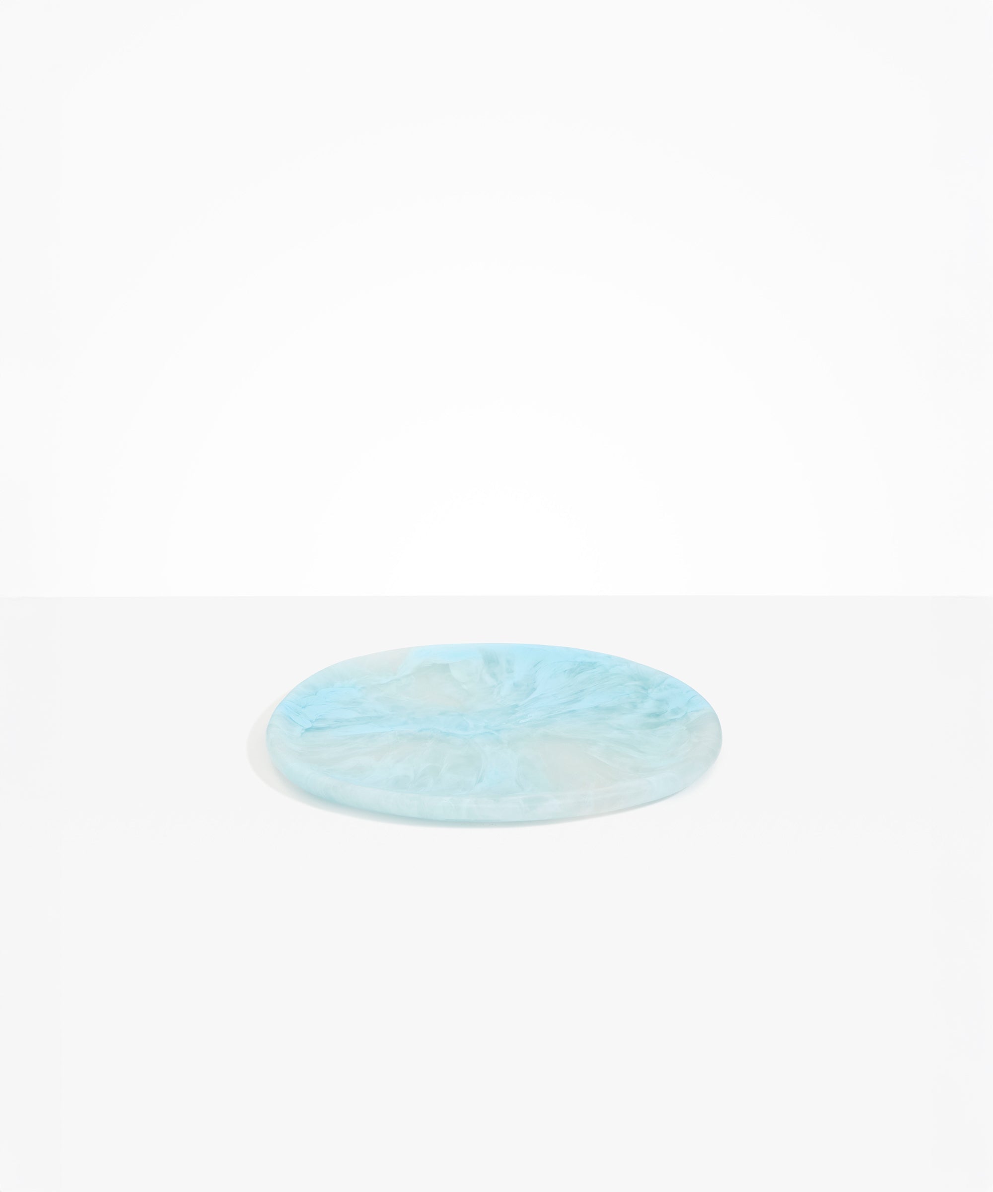 Dinosaur Designs Rock Plate in Pool — handcrafted marbled blue resin oval flat serving plate with rounded organic edge