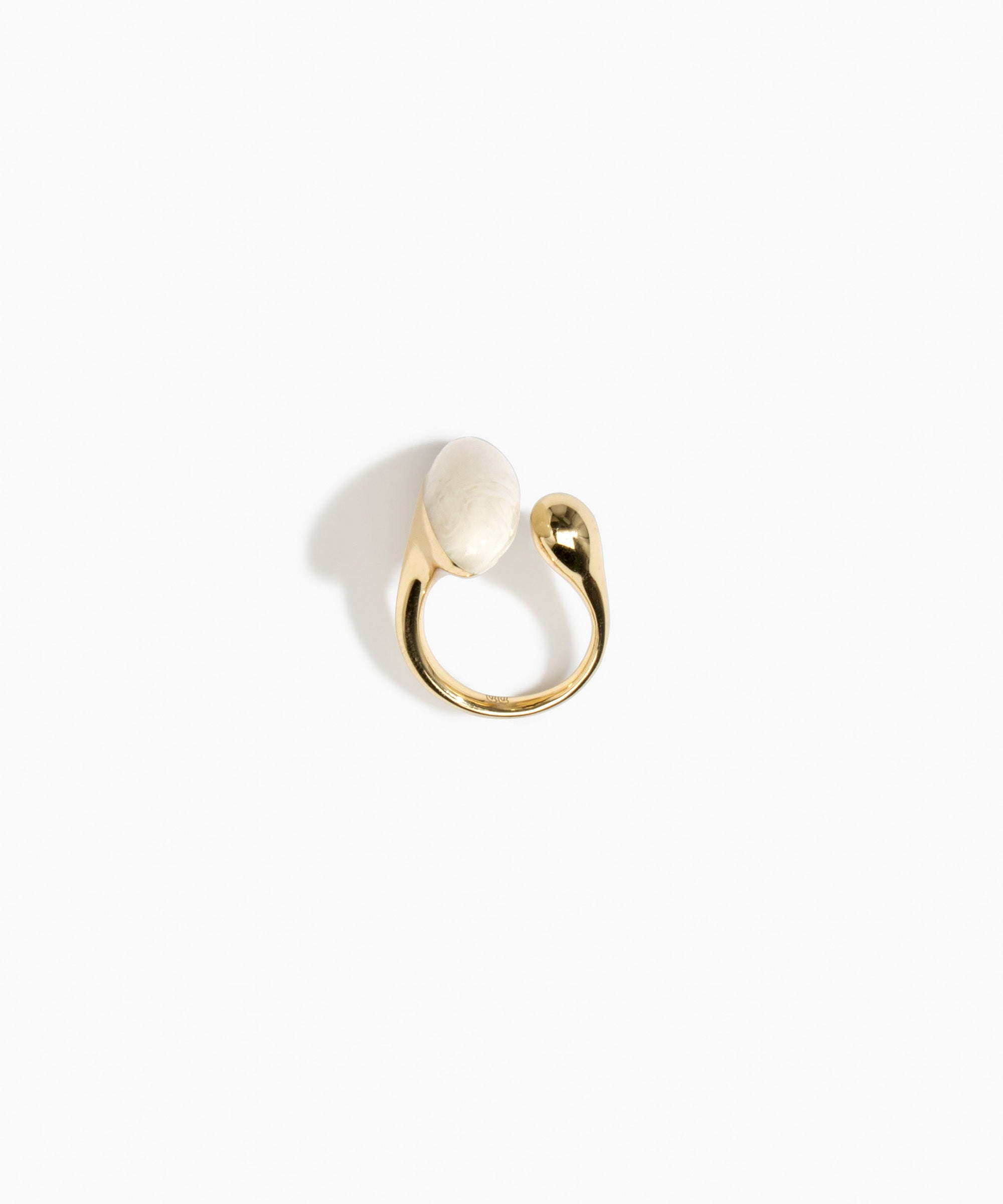 Dinosaur Designs Polished Lotus Ring in Chalk Swirl with Brass — marbled off-white resin elongated oval ring with  brass band and small brass ball detail