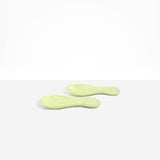 Dinosaur Designs Rock Servers in Pistachio — handcrafted marbled pale green resin salad server set with rounded bulb handles, fork and spoon.