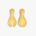 Dinosaur Designs Rock Servers in Pollen — handcrafted marbled yellow resin salad server set with rounded bulb handles, fork and spoon.