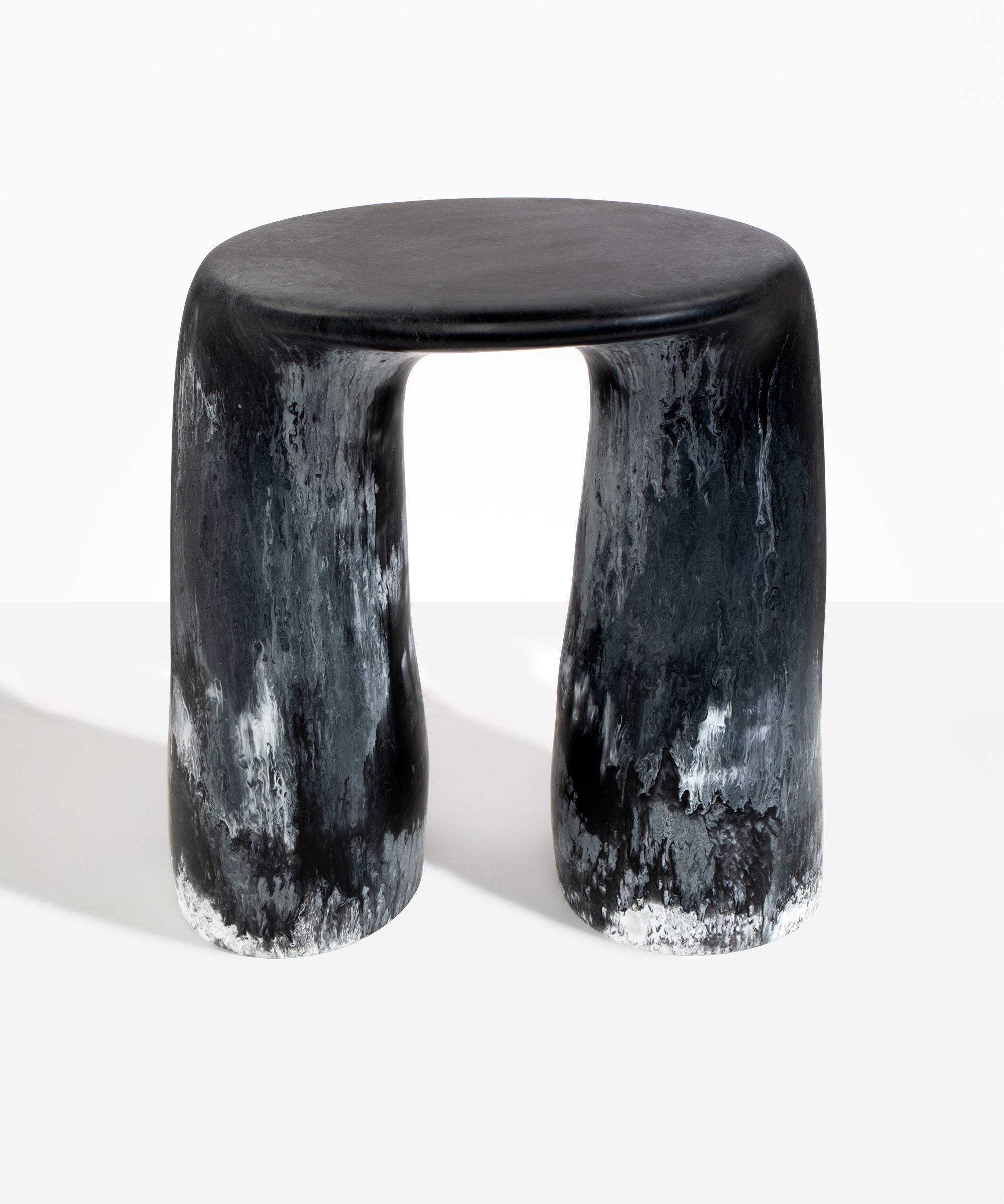 Dinosaur Designs Rock Tower Table in Black Marble — handcrafted marbled black and white resin side table with oval top and two chunky rounded legs