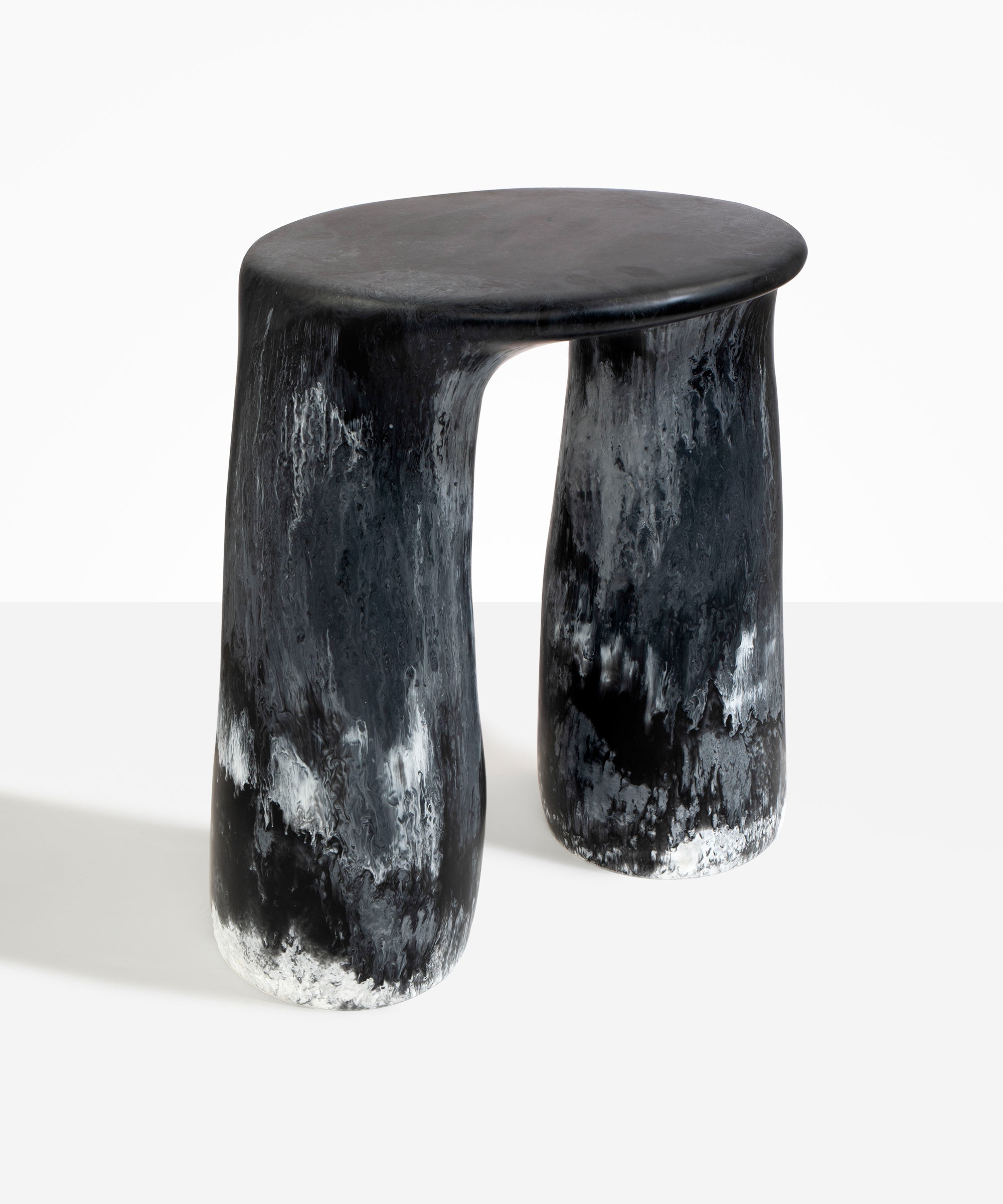 Dinosaur Designs Rock Tower Table in Black Marble — handcrafted marbled black and white resin side table with oval top and two chunky rounded legs