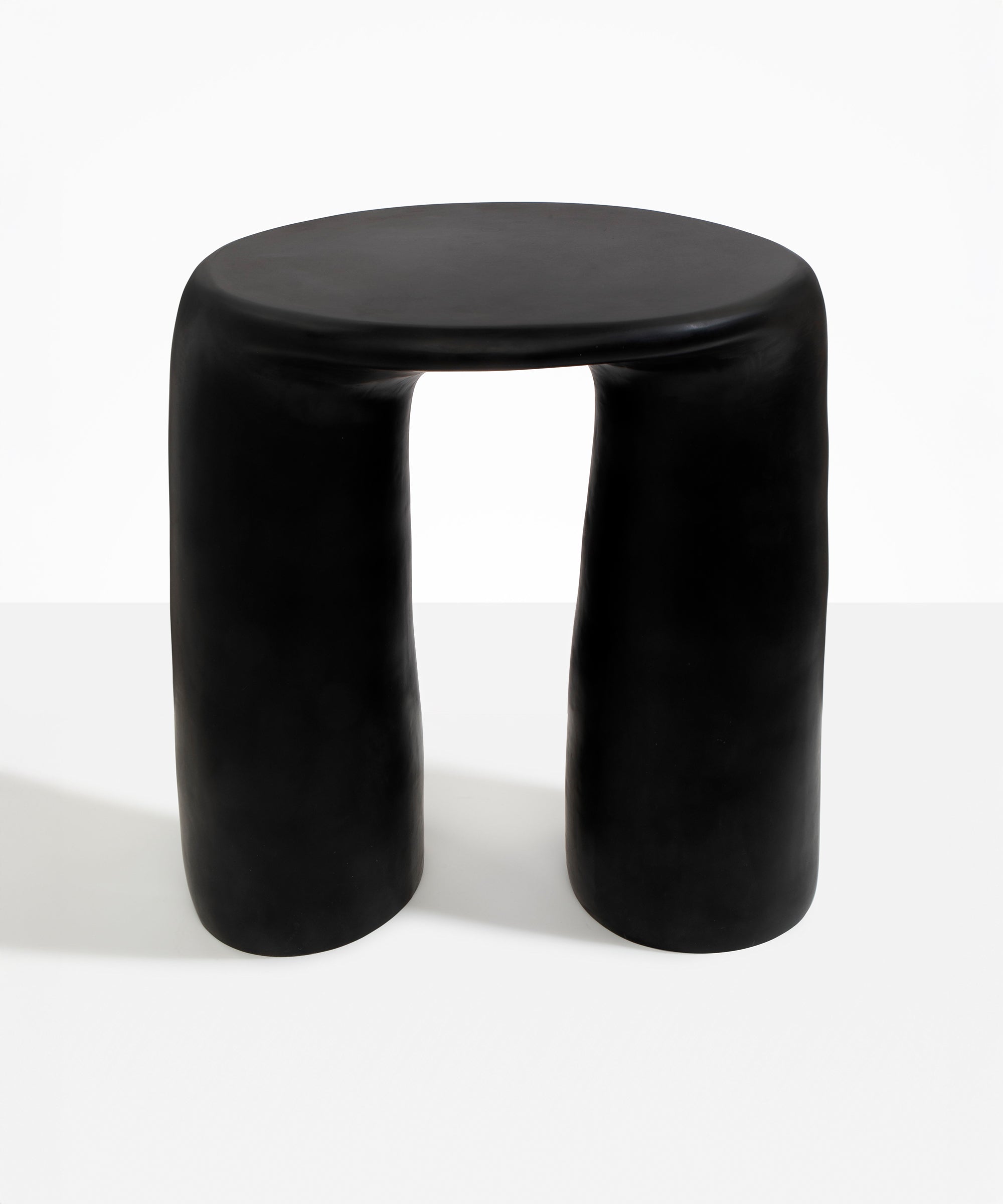 Dinosaur Designs Rock Tower Table in Black — handcrafted black resin side table with oval top and two chunky rounded legs