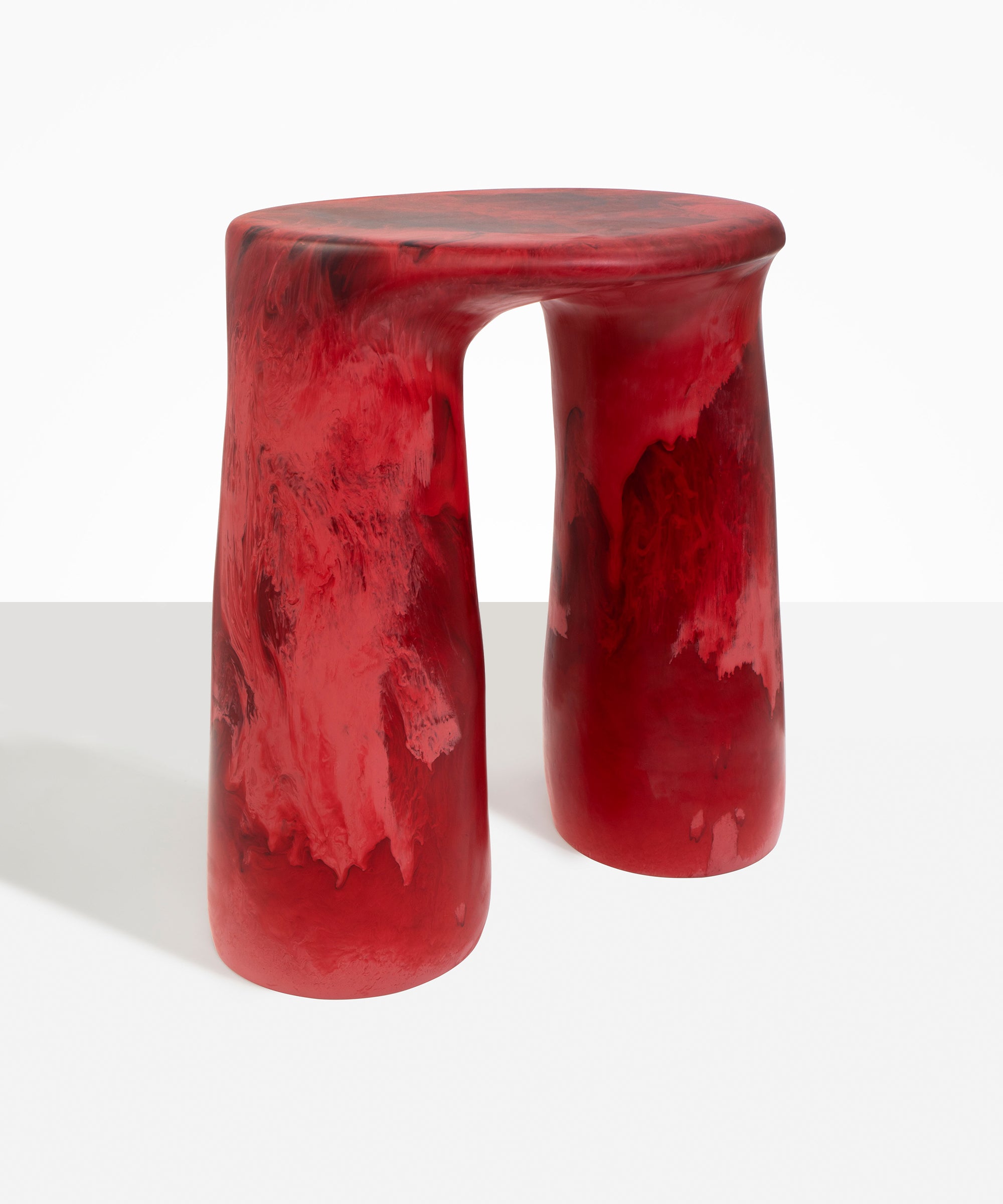 Dinosaur Designs Rock Tower Table in Cranberry — handcrafted marbled red resin side table with oval top and chunky rounded legs