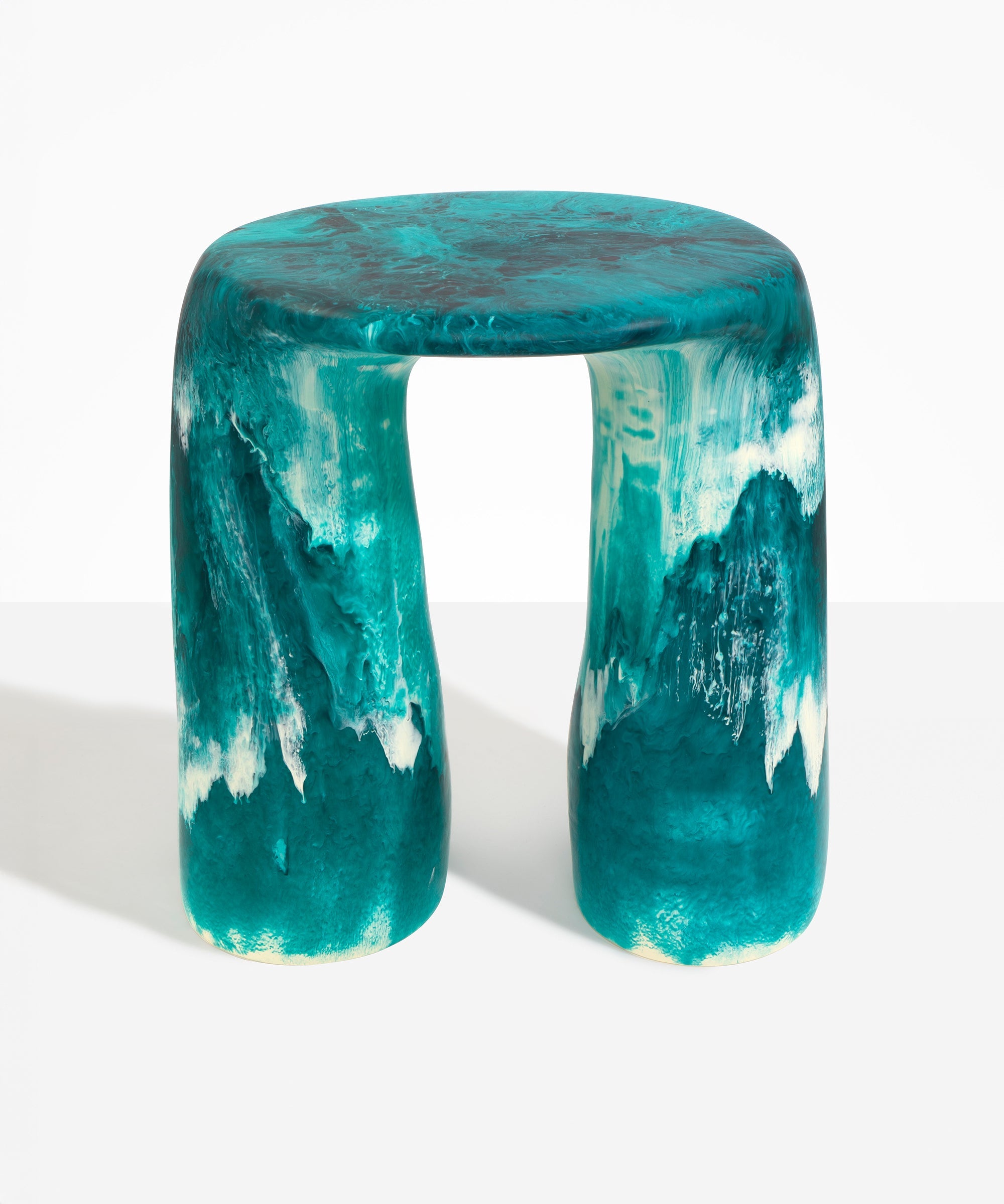 Dinosaur Designs Rock Tower Table in Lagoon — handcrafted marbled blue and cream resin side table with oval top and two chunky rounded legs..