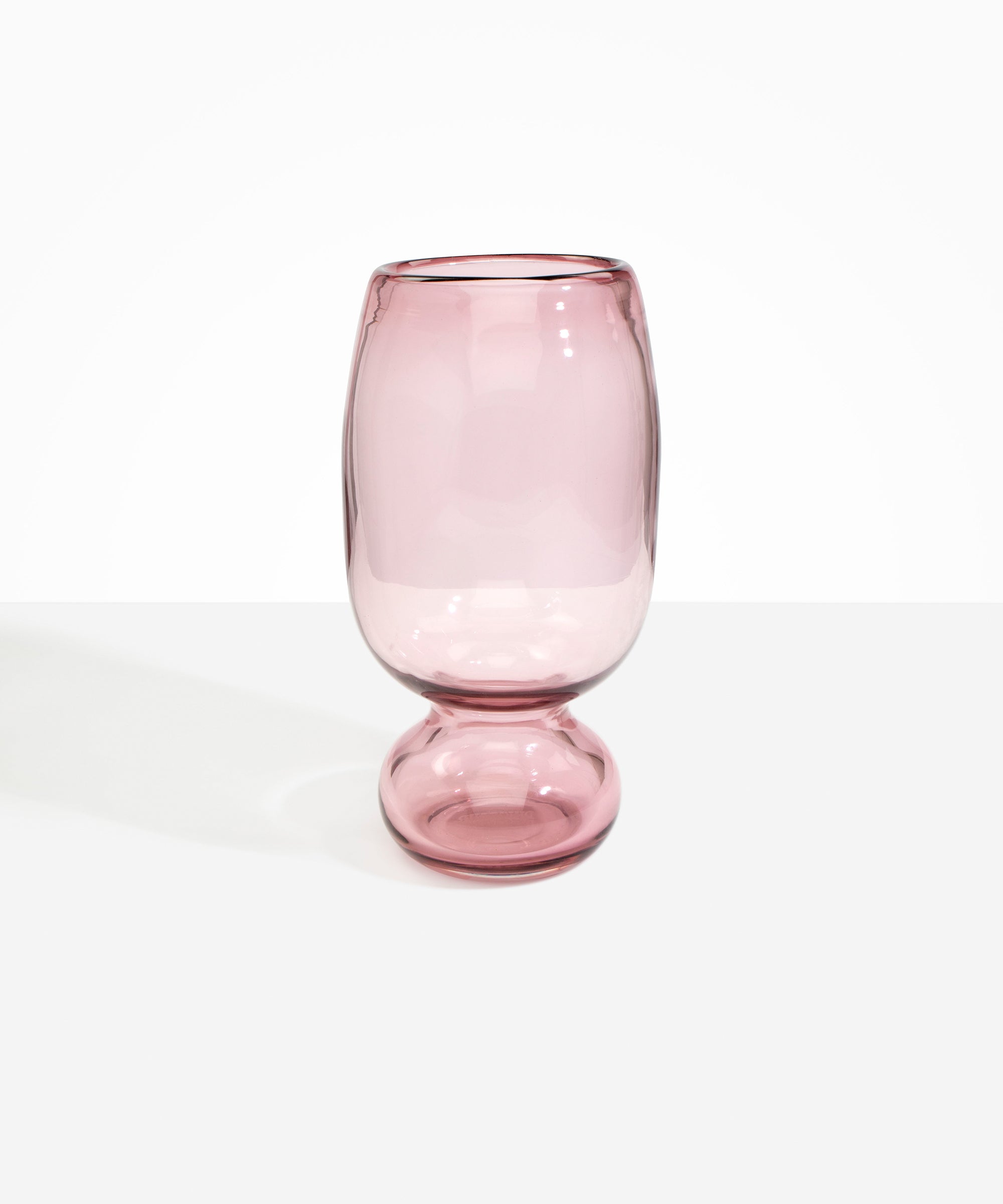 Dinosaur Designs Tall Glass Rockpool Vase in Pink — handblown transparent pink glass vase with rounded bulbous body and spherical pedestal base..